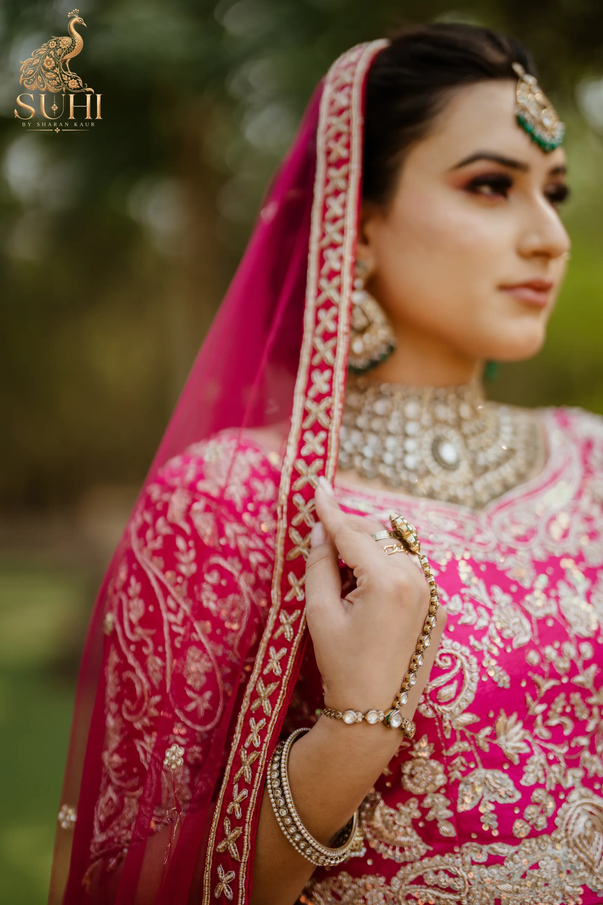 Portrait of a bride in RAANI GUL, the rose-red dupatta edged with antique-gold embroidery